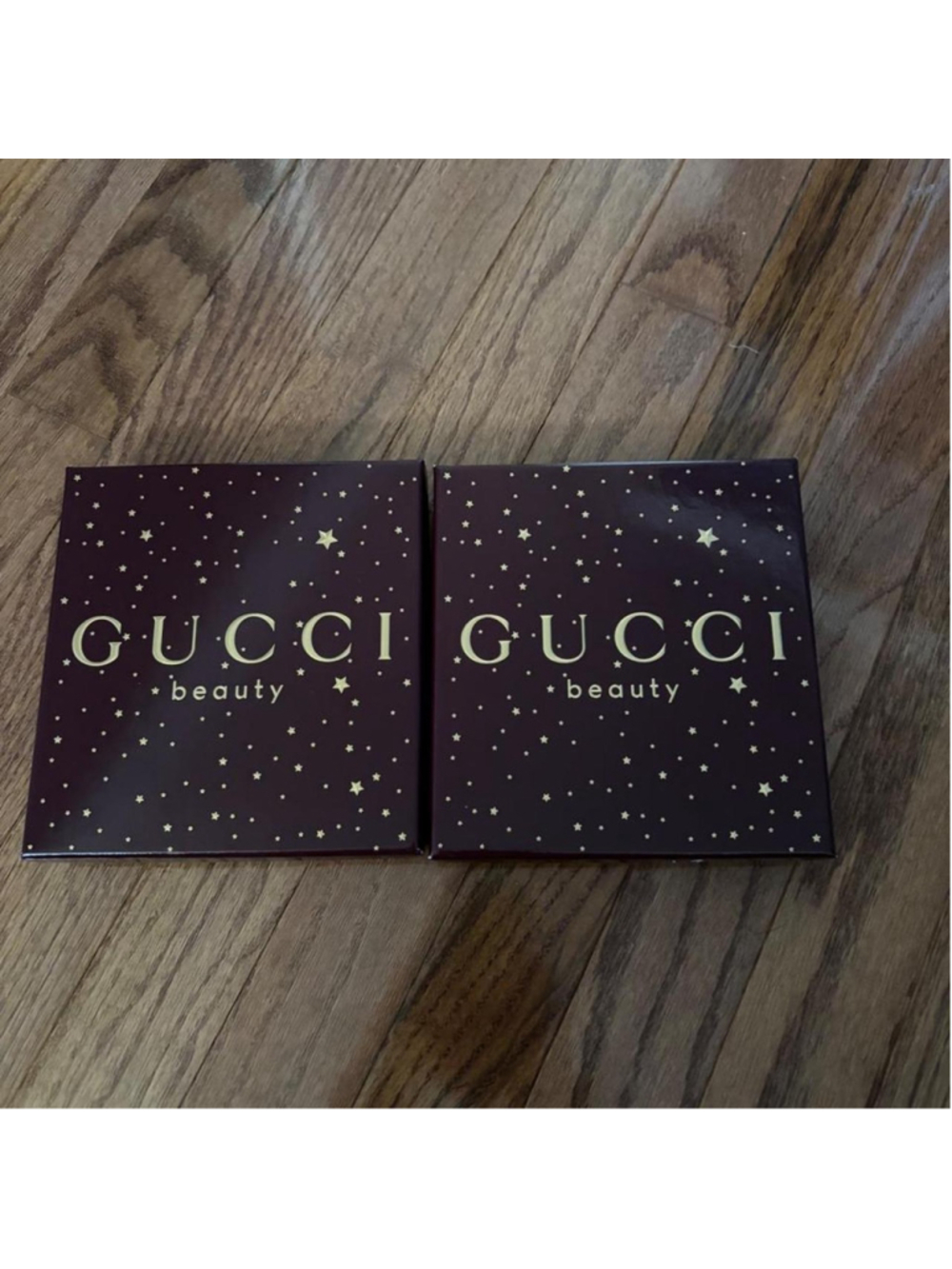 Gucci Beauty makeup boxes with gold stars on a dark background
Set of 2 empty Gu